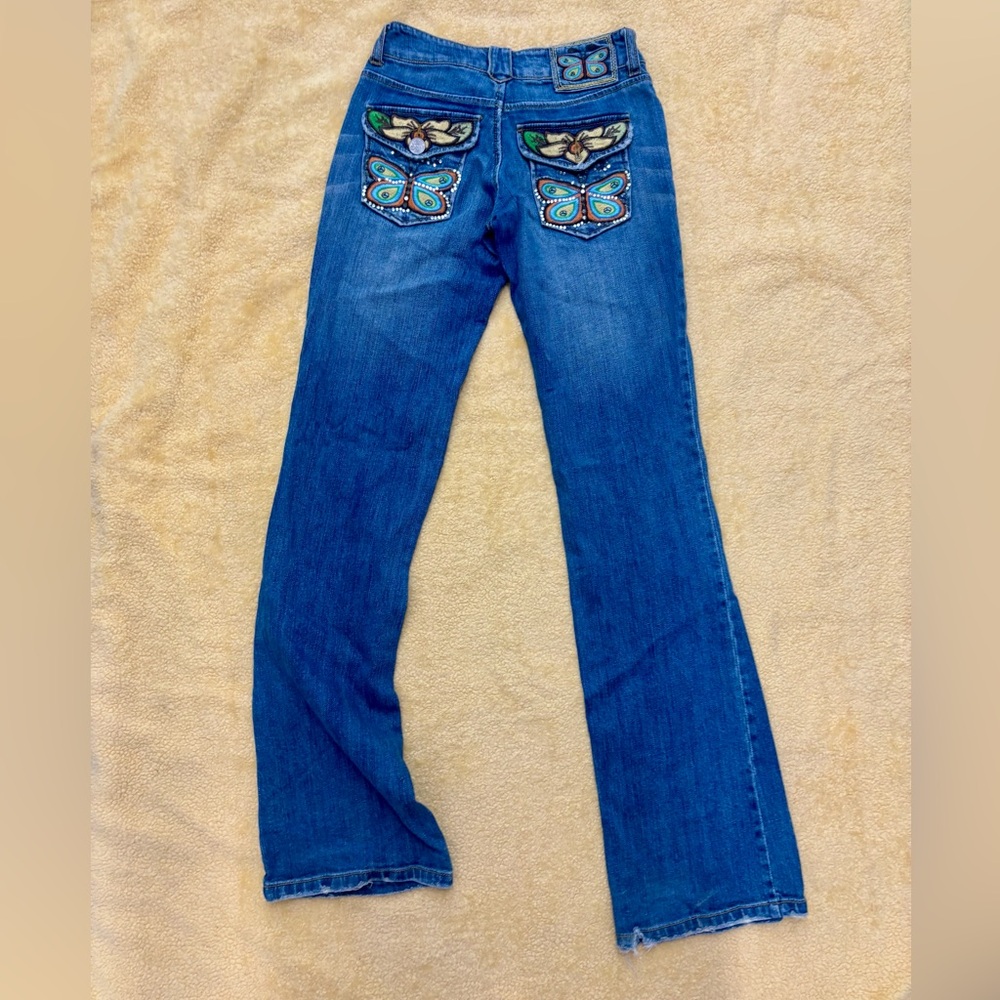 Stylish Indigo Flare Joy Jeans size 0 butterfly on back pockets